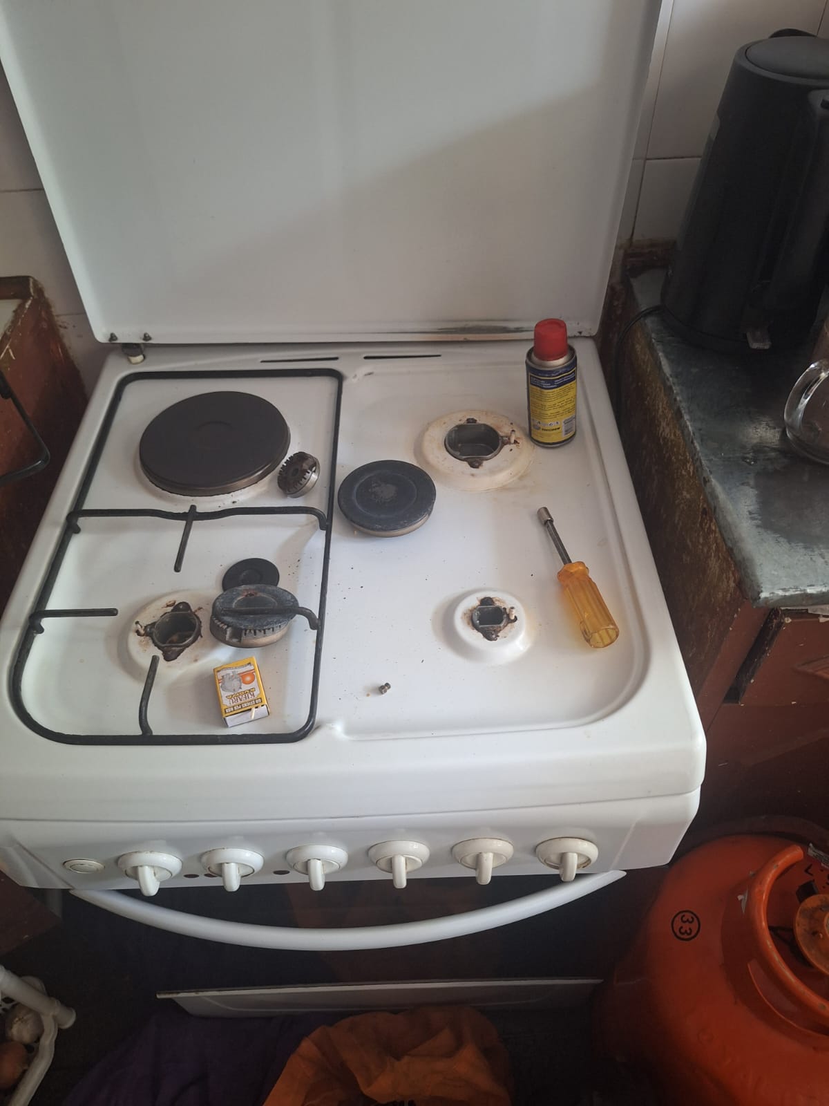Gas cooker burner repair in progress — Nairobi
